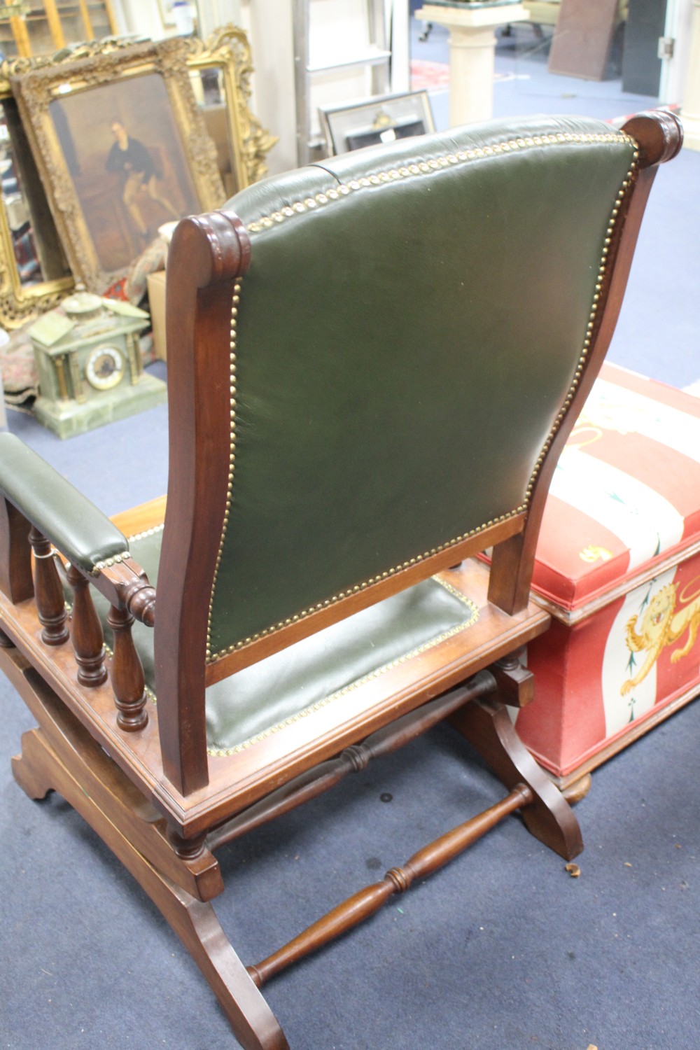 A Victorian style rocking chair with buttoned green leather upholstery, W.59cm D.74cm H.105cm
